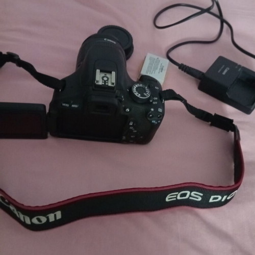 Canon EOS600D camera with 18-55mm lens, strap, charger, and two batteries