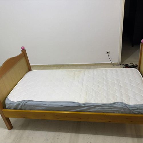 Single wooden bed with mattress, natural wood finish, pink details