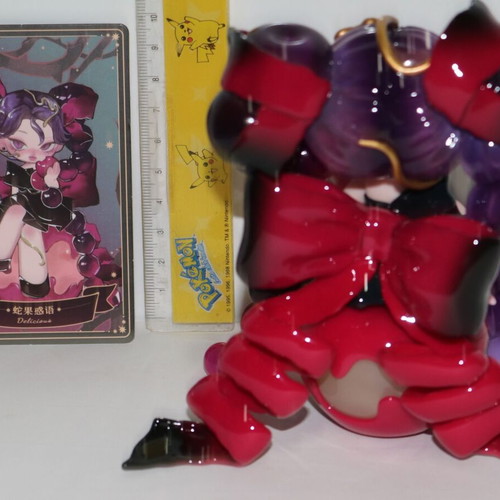 Anime cherry figure toy girl with long purple hair on cake cherry