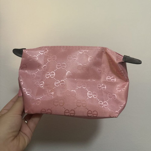 Pink toiletry bag like new with all-over logo pattern