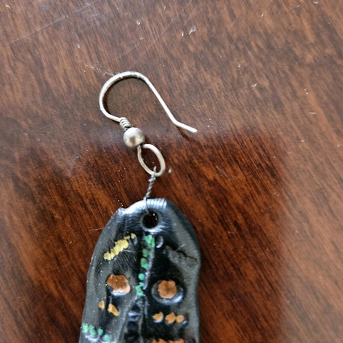 Black earring used, totem-inspired with multicolor pattern