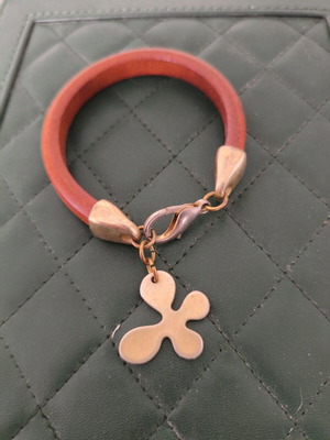 Wooden bracelet like new with gold details and clover charm
