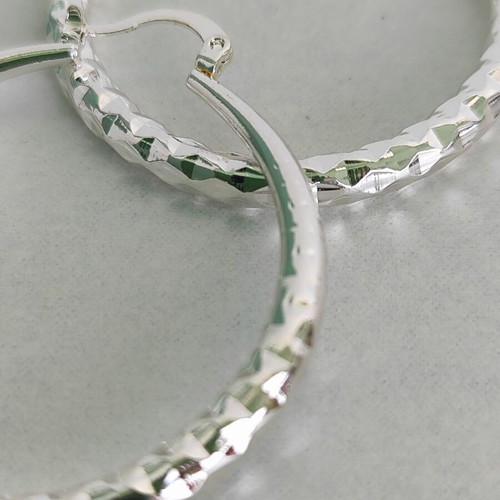Silver-tone hoop earrings like new with diamond-cut texture