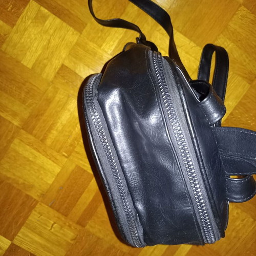 Backpack black leather type used with multiple pockets