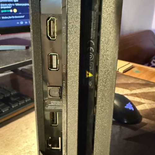 PlayStation 4 Pro used with controller and two games