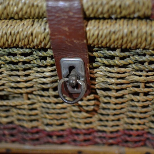 Vintage wicker storage basket used with leather strap and metal clasp