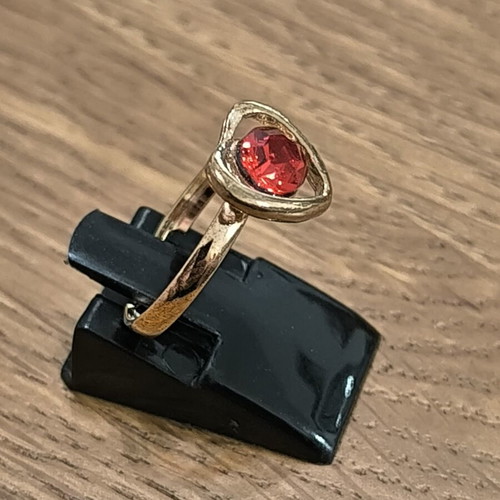 Gold-colored ring with heart and red stone, new