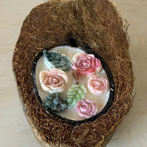Handmade candle in natural coconut shell
