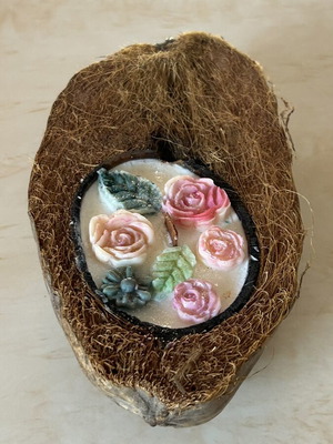 Handmade candle in natural coconut shell