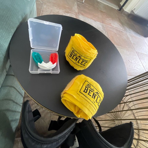 Kick boxing equipment used with gloves, wraps, shin guards, mouthguard, and bag