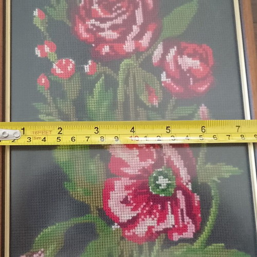 Vintage cross stitch picture of roses and poppies