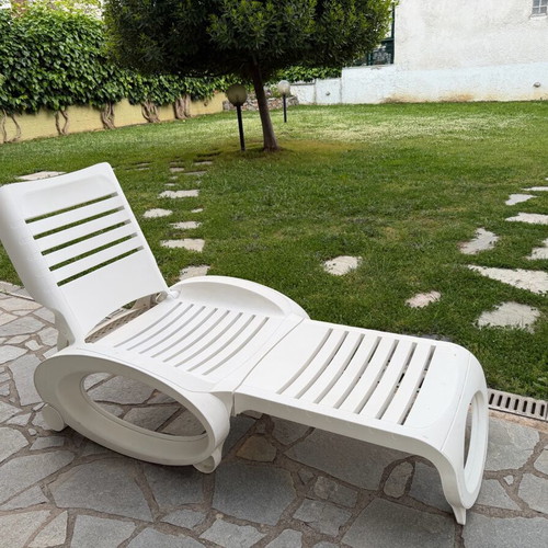 Plastic sun lounger used with wheels and adjustable backrest