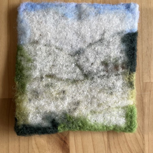 Handmade wool felt landscape picture with sheep