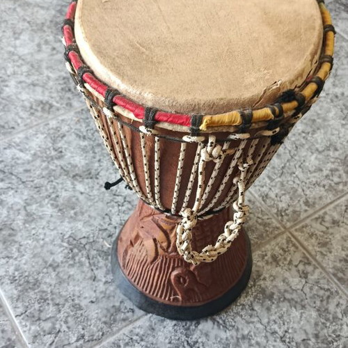 Wooden African drum with carved details and leather membrane