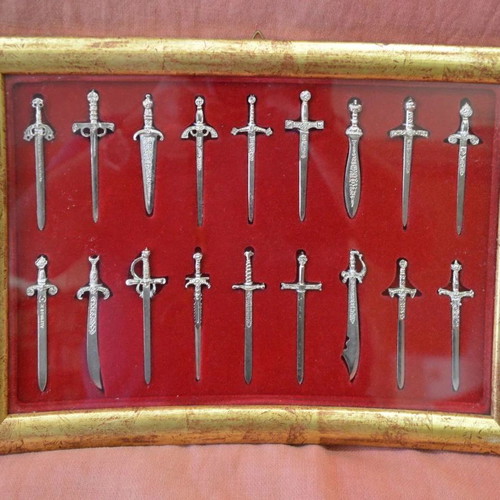 Collectible frame with 18 silver miniature swords and daggers