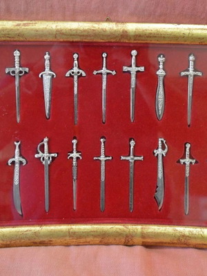 Collectible frame with 18 silver miniature swords and daggers