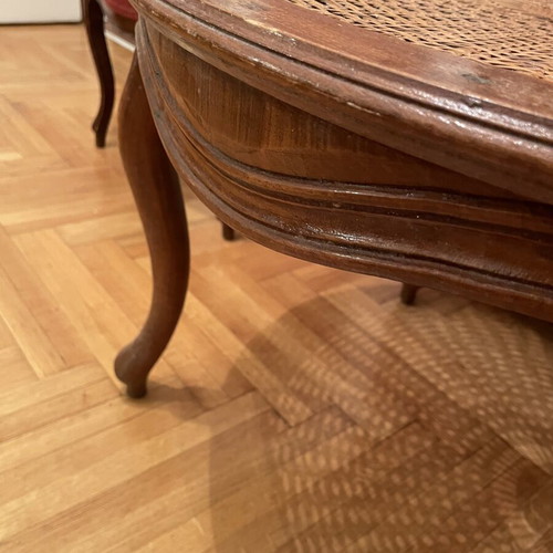 Oval living room coffee table with rattan and carved medallion
