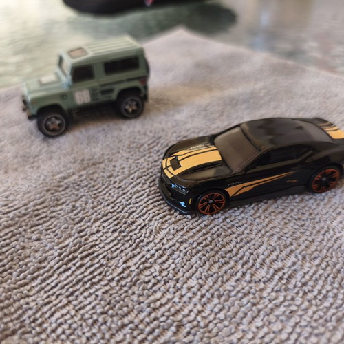 Land Rover Defender and Cord Camaro toy cars, set of 2