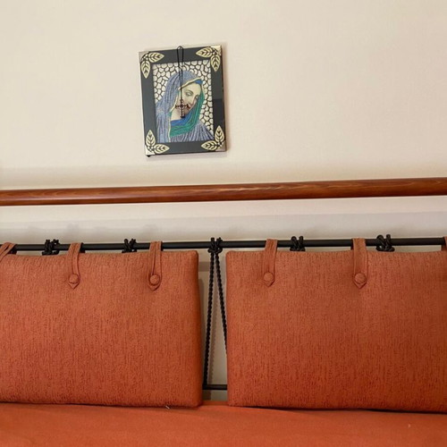 Double bed with black metal frame and wooden headboard
