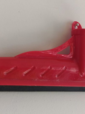 Red plastic floor squeegee with black rubber blade