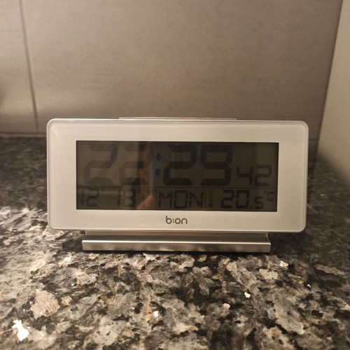 Digital table clock used with thermometer and alarm