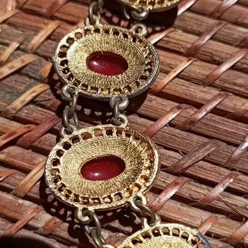 Vintage necklace used with red stones and brass metal