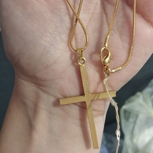 Gold-colored cross necklace with rhinestones