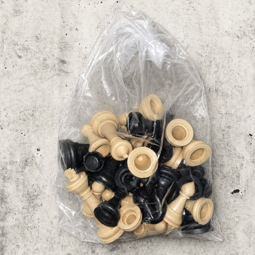 Set of black and white plastic chess pieces