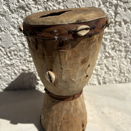 Handmade wooden drum used, African style with leather membrane and shells