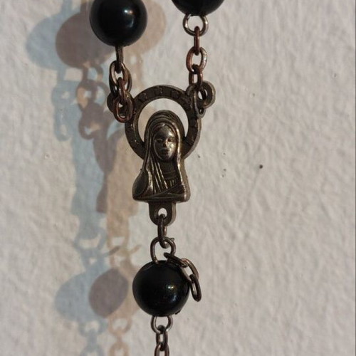 Traditional rosary used, black beads and silver elements