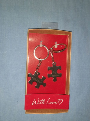 Keychain set with puzzle pieces and "Better Together" message, new
