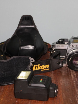 Nikon FG-20 film camera with leather case and flash