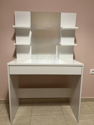 White makeup vanity table with drawer and shelves
