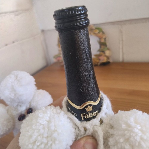 Faber champagne or wine bottle with knitted white dog