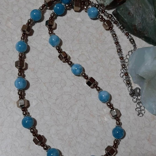 Necklace with dark blue larimar and gold hematite on steel