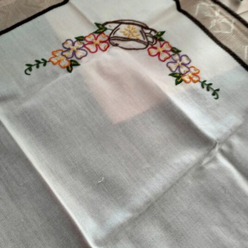 Embroidered square table linen with coffee cup and floral design