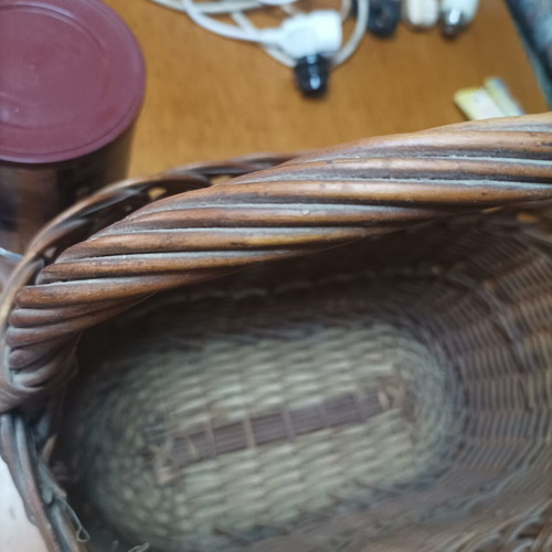 Handmade dark brown wicker basket with high arched handle