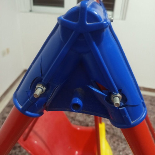 Child swing with metal frame and plastic seat, used with plastic wear