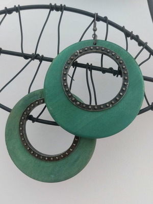 Wooden earrings used, large green circular design with metal details