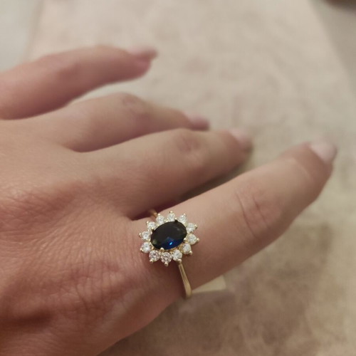 Women's rosetta ring new, gold color with blue oval stone and zircons
