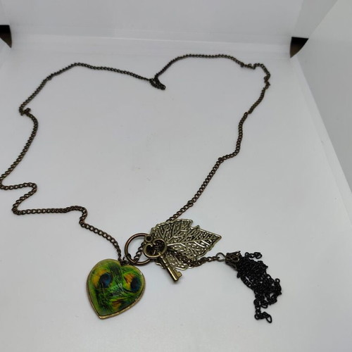 Vintage necklace with antique bronze elements and peacock feather heart pendant like new