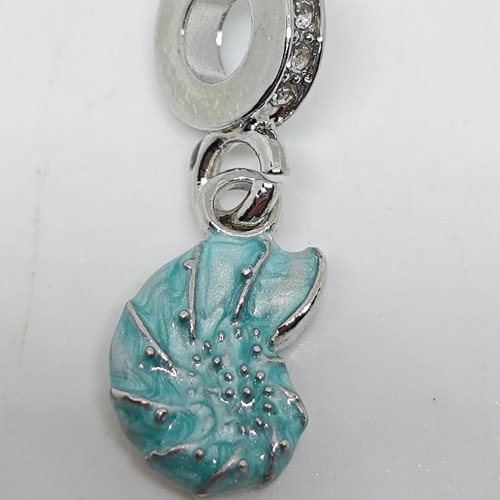 Silver charm with blue enamel Nautilus like new