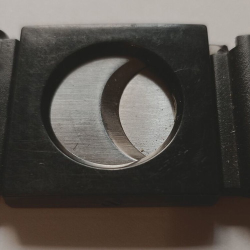 Black plastic cigar cutter used with metal cutting edges
