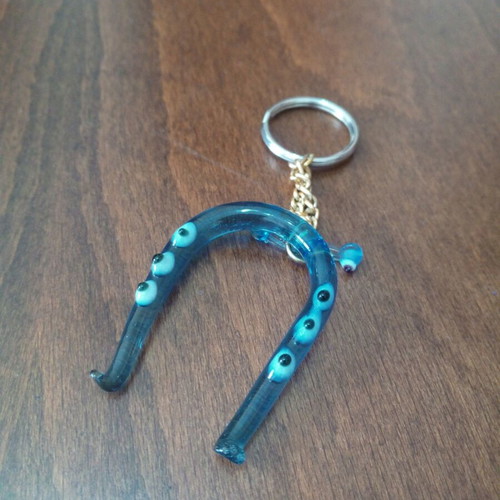 Glass horseshoe keychain used with blue evil eyes