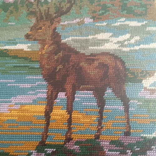 Handmade cross-stitch embroidery in wooden frame, used
