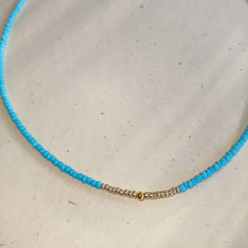 Handmade necklace with gold and blue beads