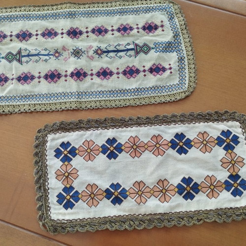 Vintage handmade embroidered table linens with cross-stitch and gold thread