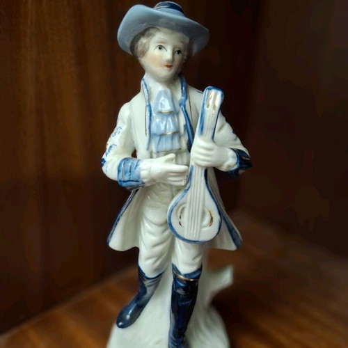Porcelain figurine set used, woman with lyre and man with mandolin