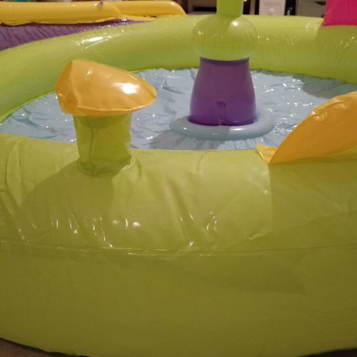 Inflatable colorful playpen used with balls and slides
