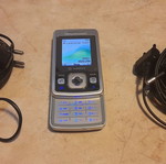 Sony Ericsson cell phone used with 2 chargers silver